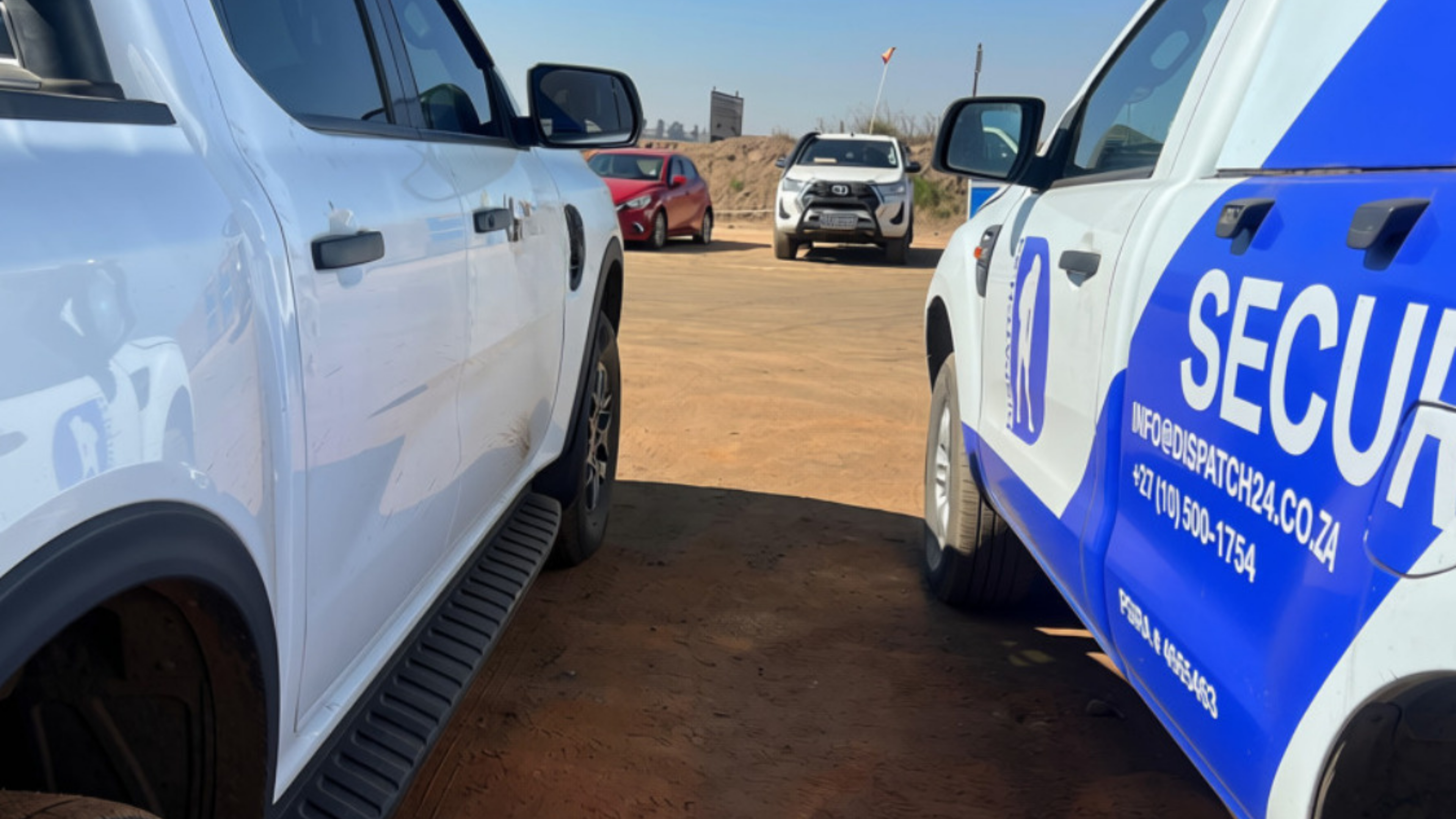 D24 Security patrol vehicle at a mine access gate alongside a client vehicle