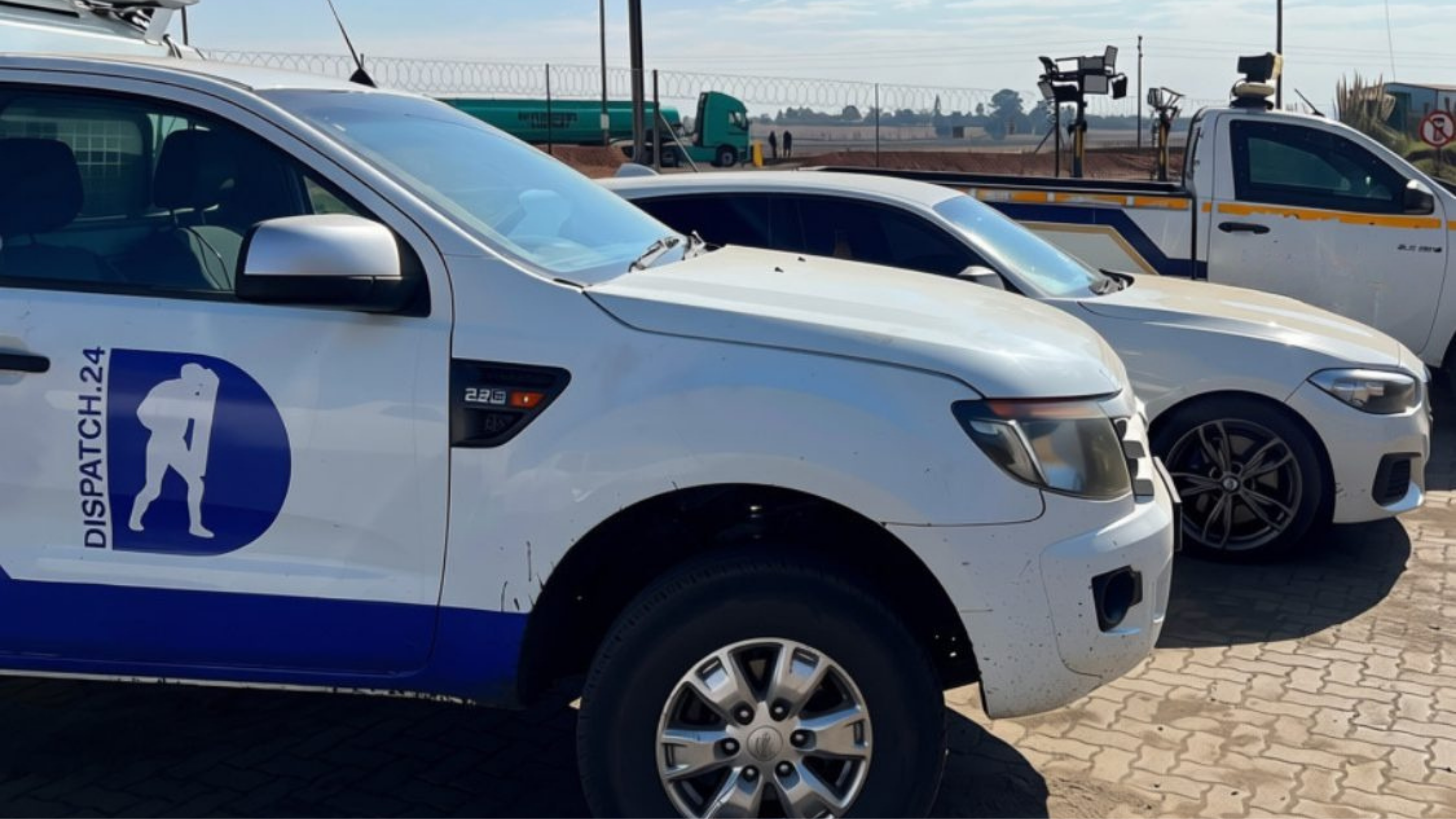 D24 Security patrol vehicles lined up on a client yard in daylight